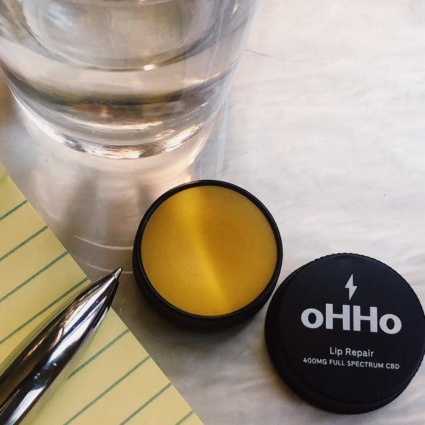 Lip balm, plant based, nourishing, oHHoA full spectrum CBD lip balm containing beneficial minor cannabinoids and terpenes complemented with a blend of all-natural moisturizing and soothing ingredients. Peppermint and grapefruit bring a cooling and zesty feel with antibacterial and pain relieving properties. Packed with vitamins A and E, omega 3, 6 and 9, our lip balm is designed to improve hydration, ease inflammation and protect for perfectly kissable lips.